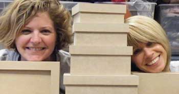 Kim & Holly up to their necks in boxes!