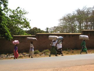 Ladies walking with huge sacks on their heads