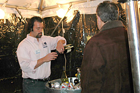 Avi spells the bartender in the outside tent.
