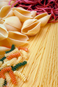 FOD701FM 003 001-Arrangement of uncooked pastas including shells & multi-colored rotini x071003 
