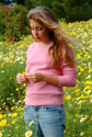JRH565FM 005 001-White JH girl picks petals of sunflower on field in spring